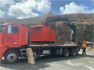 NES unloading a generator off a truck in a power emergency.